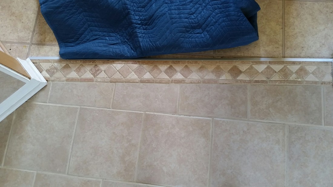 Picture of tile and grout after being cleaned by the kitchen entrance