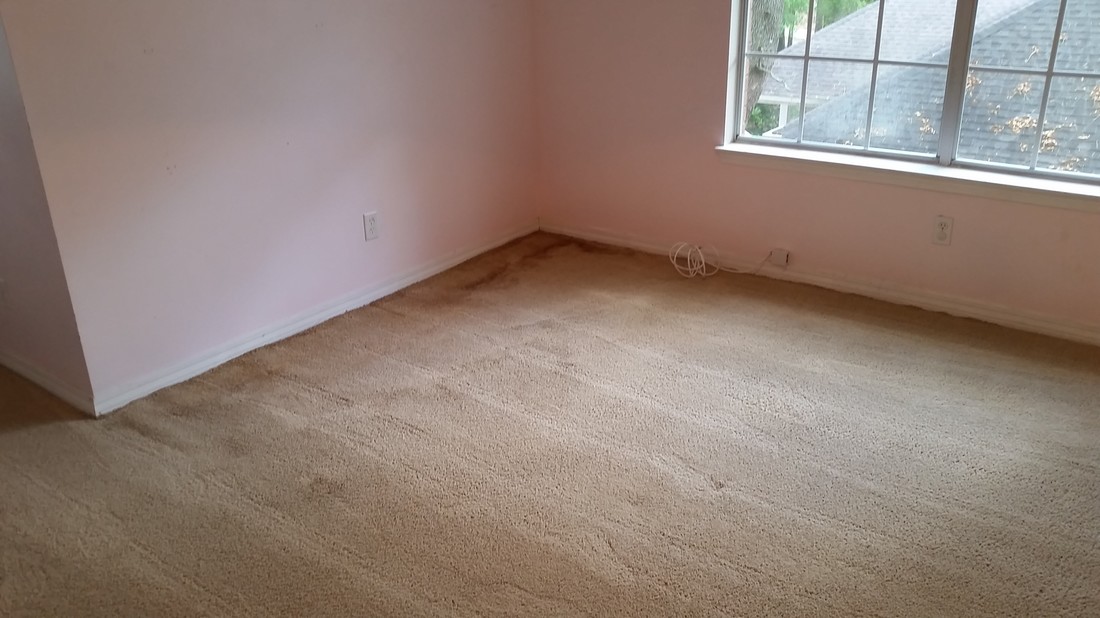 Picture of a bedroom carpeting before cleaning with water stains in the corner from a roof leak. Carpet cleaning in Daphne, AL. by Absolutely kleen