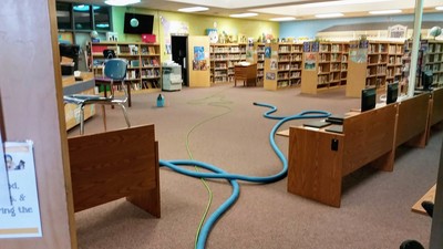Cleaning carpet in the library at Daphne Middle School by Absolutely Kleen