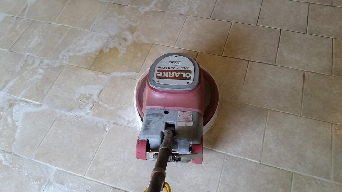 Picture of a mechanical scrubber being used to clean the tile and grout by Absolutely Kleen